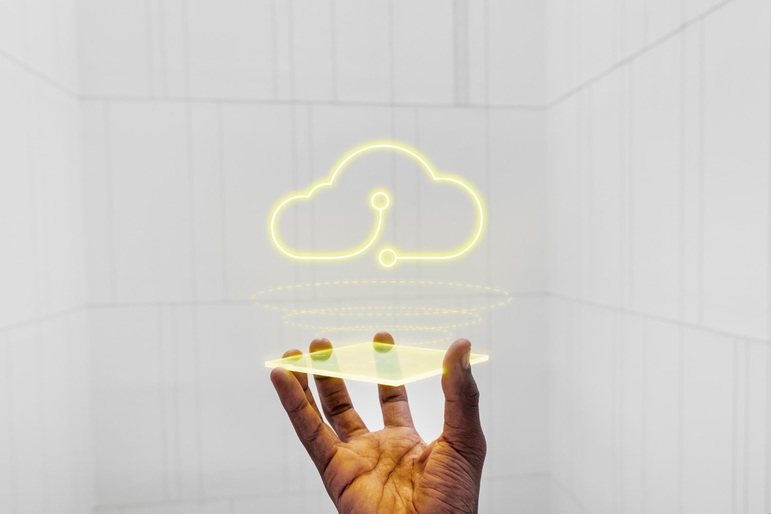 Hand holding a glowing holographic cloud icon